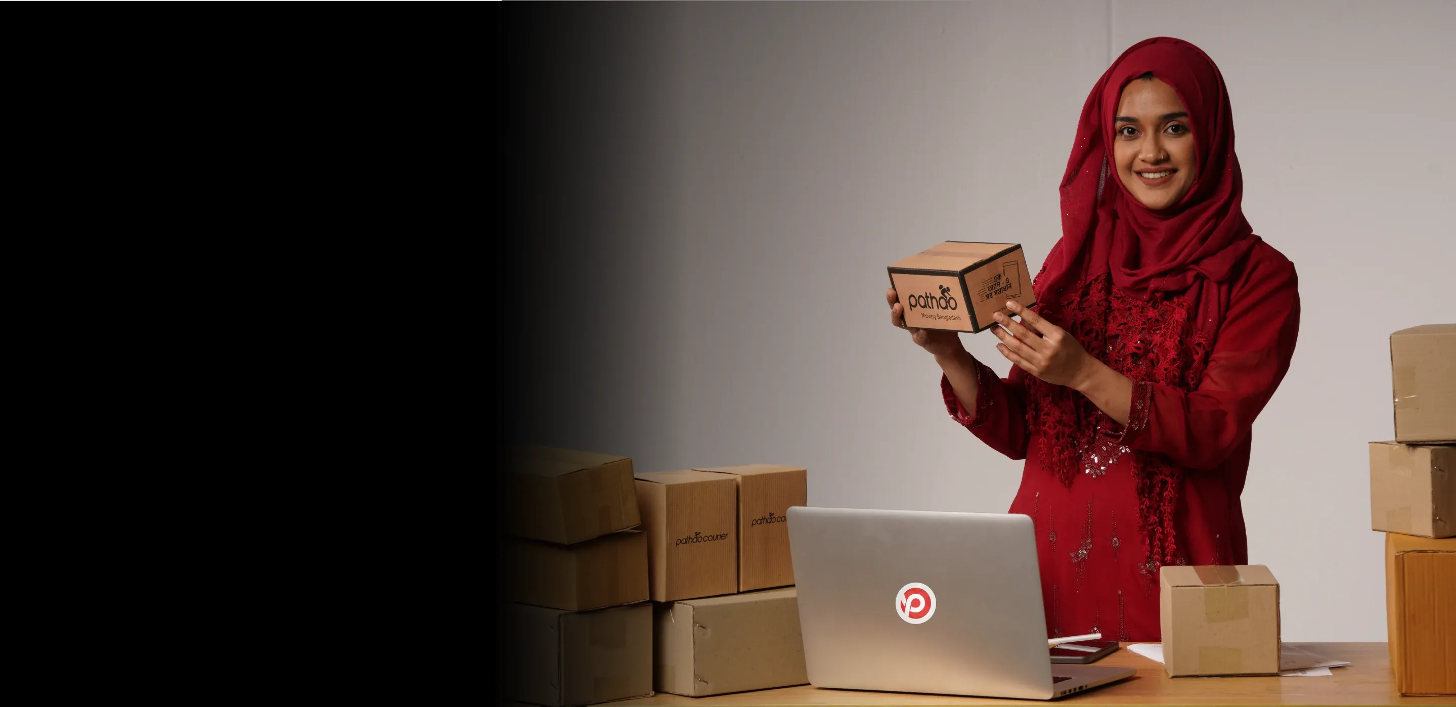 Merchant holding a Pathao courier box